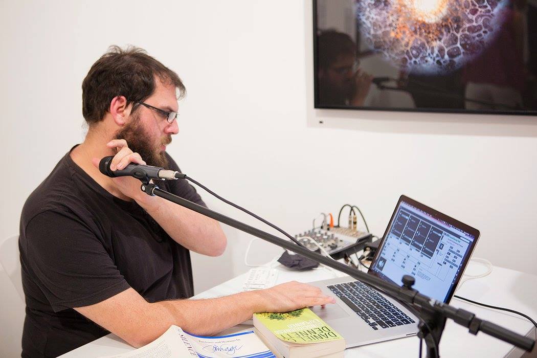 A photo of Vincent performing live in an art gallery.